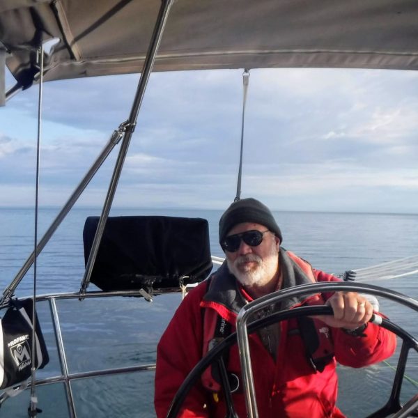a man sitting in a boat on a body of water
