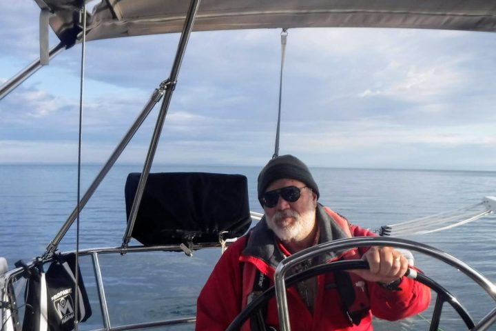 a man sitting in a boat on a body of water