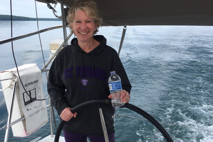 Women steering large sailboat