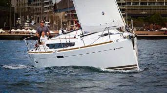 white sailboat cruising close to harbor