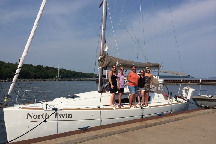 Group of women standing on sailboat