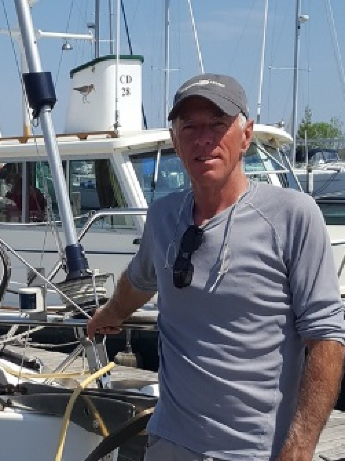 Joe-Radtke Crew member Joe standing next to sailboat