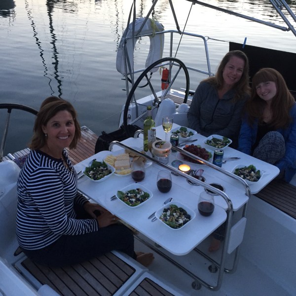 Ladies dining on back of sailboat