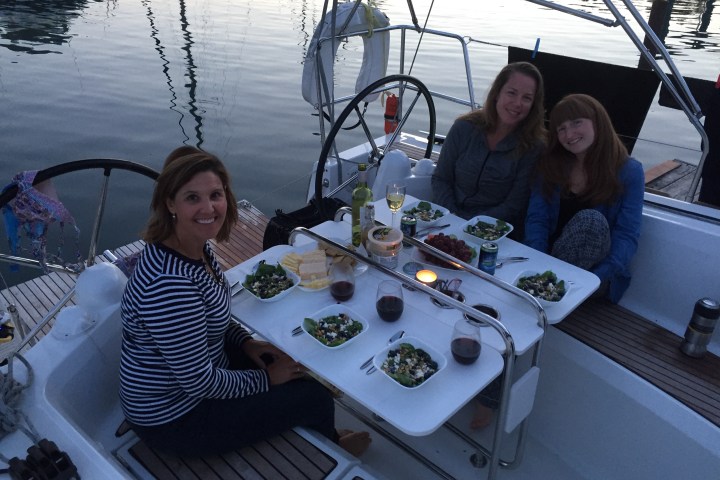 Ladies dining on back of sailboat