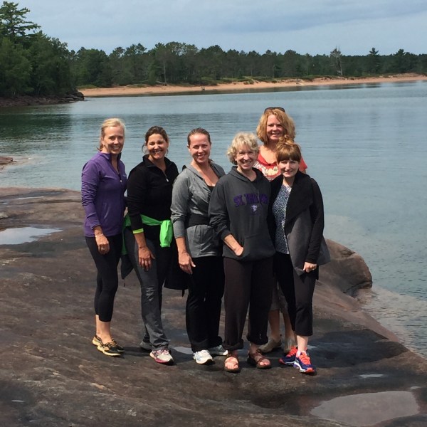 Group of ladies standing on lake beach