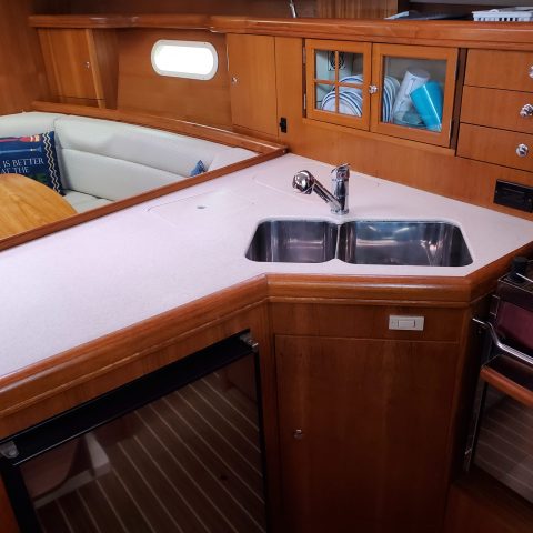 a kitchen with wooden cabinets and a table
