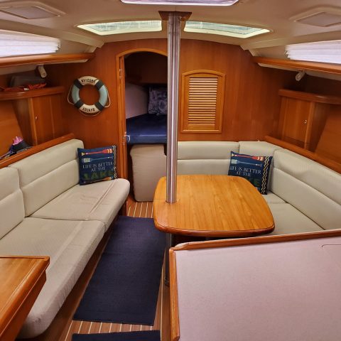 a kitchen with wooden cabinets and a table in a room