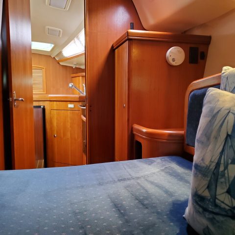 a bedroom with a bed and desk in a room