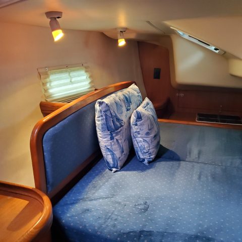 a person in a blue suitcase on a bed