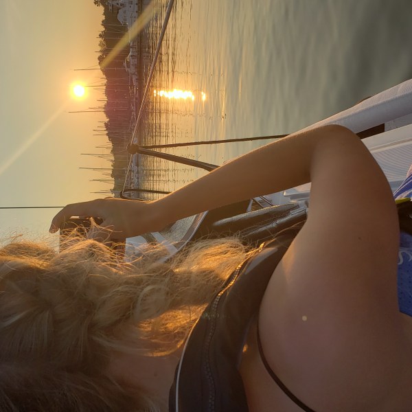 a girl taking a photo of the sunset