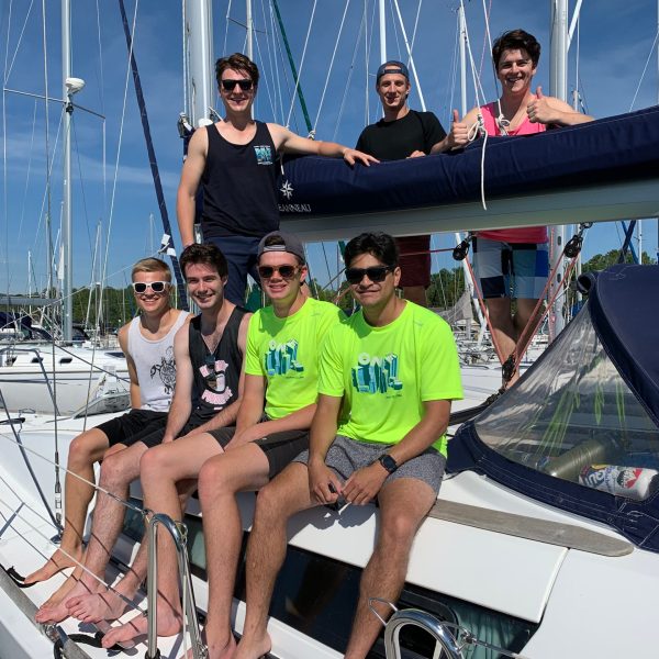 a group of people on a boat posing for the camera