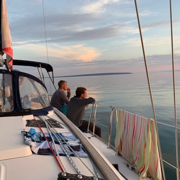 a group of people in a boat on a body of water