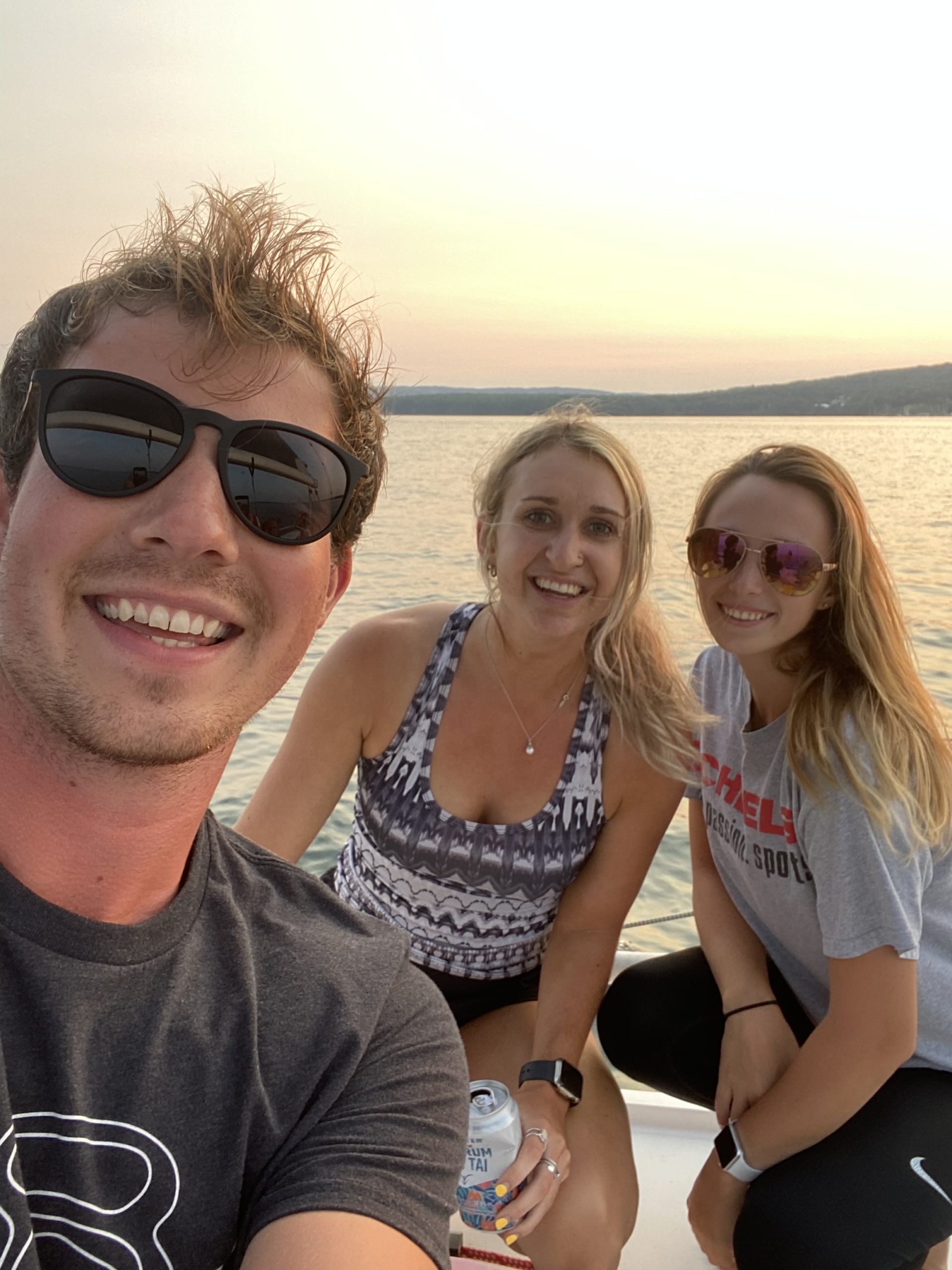 Viktoriya Kutuzova et al. posing for a picture next to a body of water