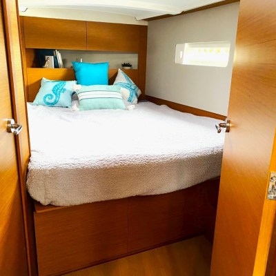 a bedroom with a bed and a mirror