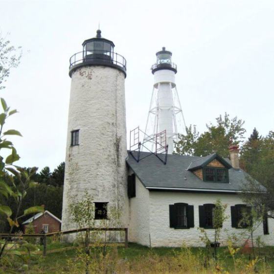 a lighthouse with another lighthouse behind it