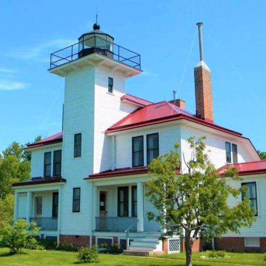 a lighthouse with green grass
