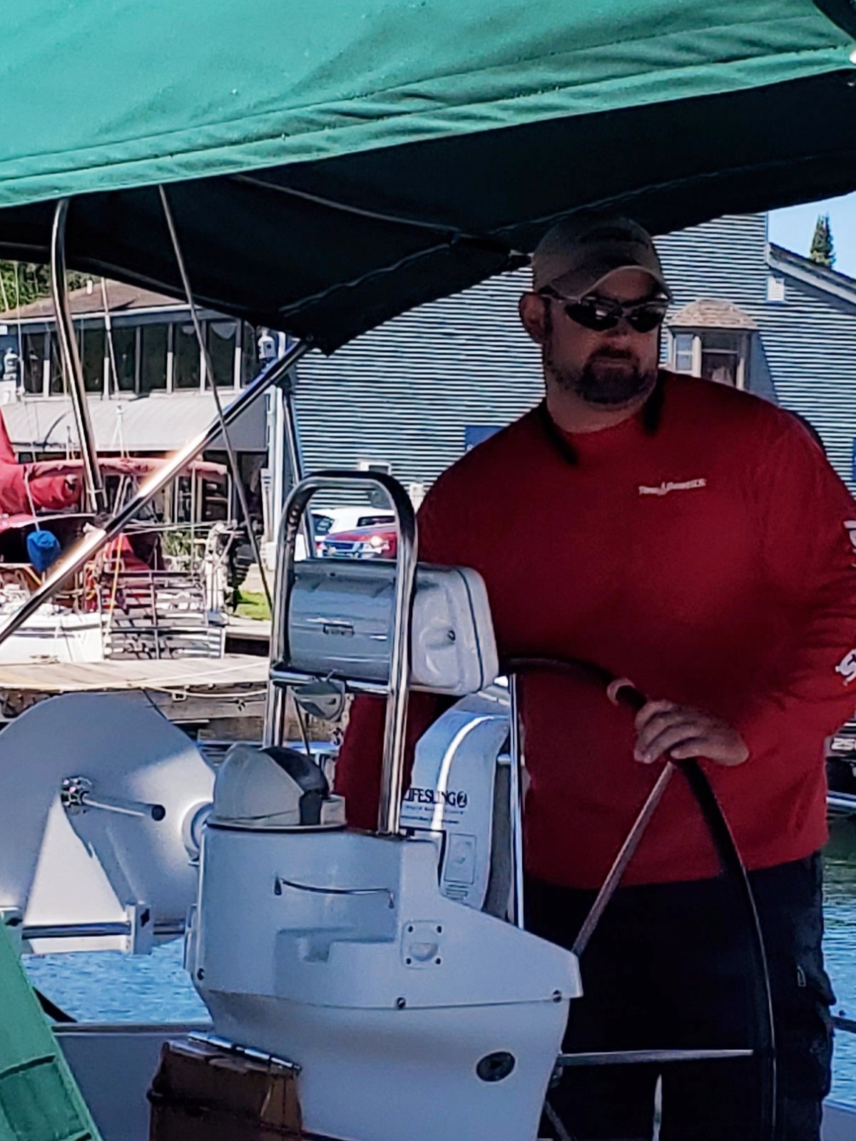 Joey a man standing next to a boat