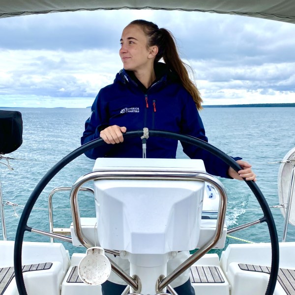 a person sitting in a boat on a body of water