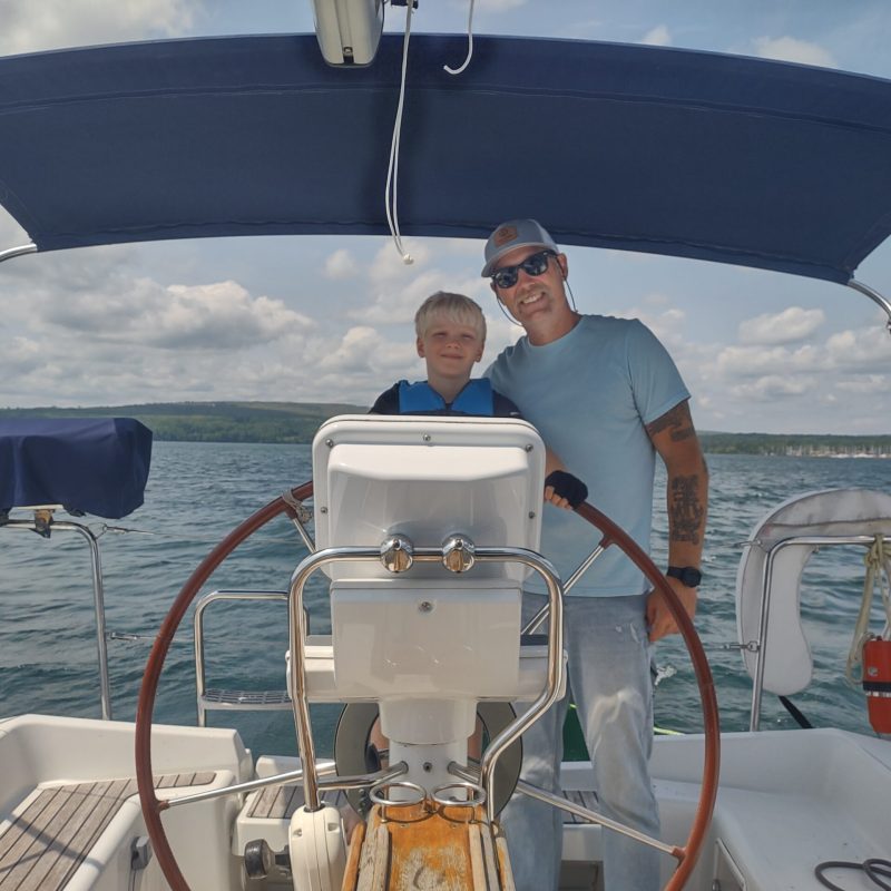 a man and his son in a boat on a body of water