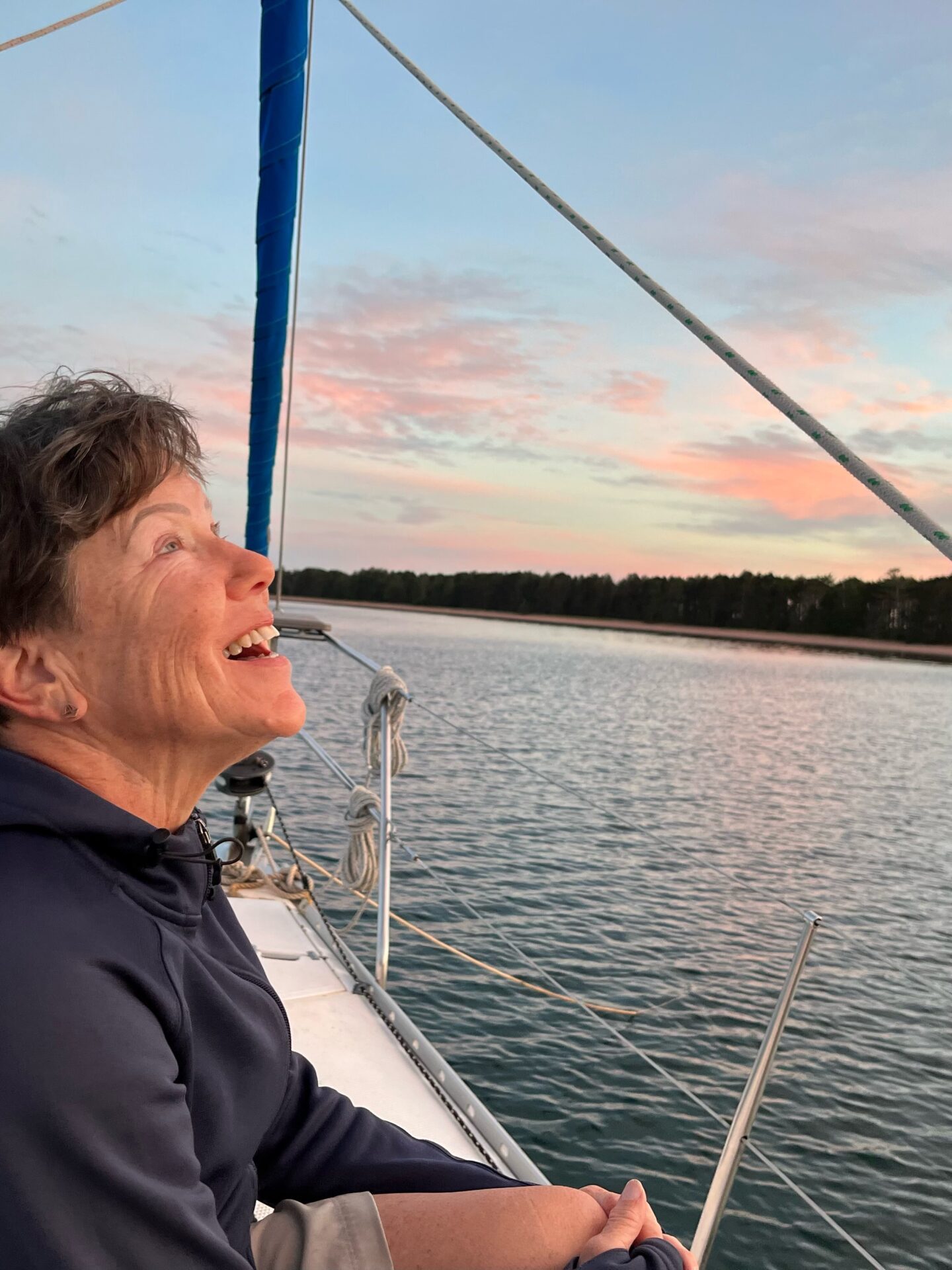 Captain Vicki a man standing in front of a boat next to a body of water