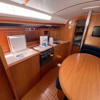 a desk with a laptop computer sitting on top of a wooden chair