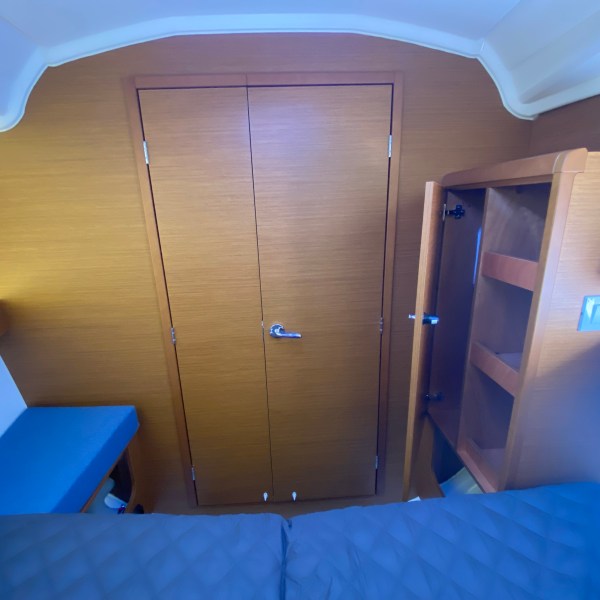 a bedroom with a bed and desk in a small room