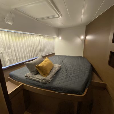a bedroom with a bed and desk in a room