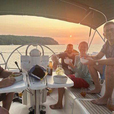 a man and a woman sitting on a boat in the water