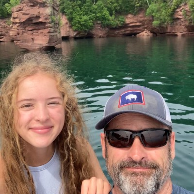 a man standing next to a body of water