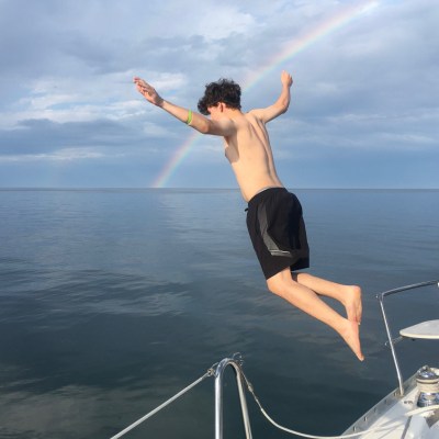 a person standing next to a body of water