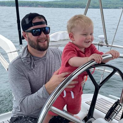 a man sitting in a boat on a body of water